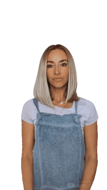 Animated gif of a blond woman with a pale purple shirt and denim overalls mouthing "facts" and pointing upward with two hands