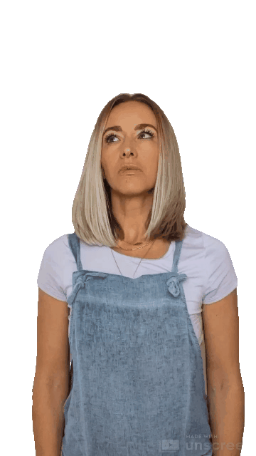 Animated gif of a blond woman with a pale purple shirt and denim overalls brings fist across her body in the universal sign of "shucks"