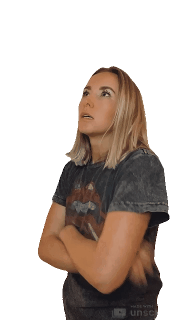 Animated gif of a blond woman wearing a dark grey rolling stones tshirt has arms crossed and huffs, clearly impatient